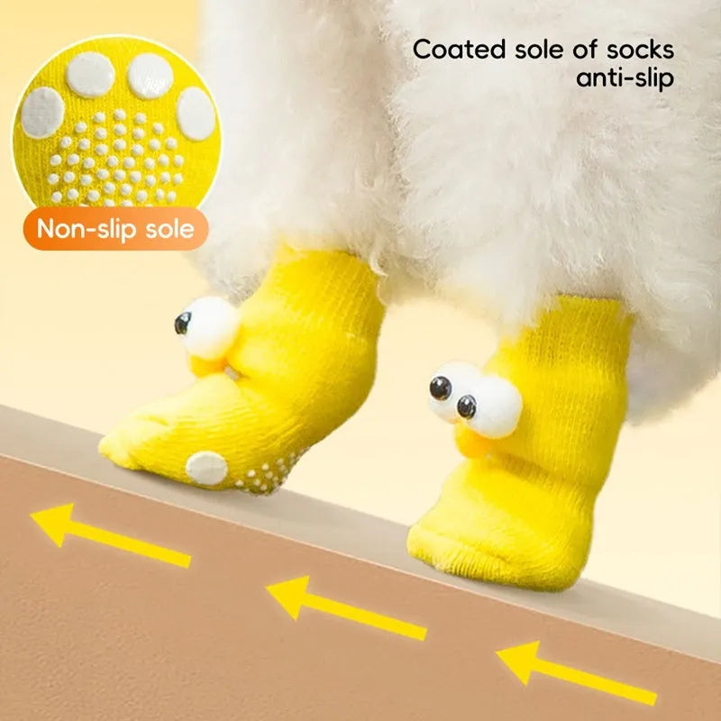 Dog wearing green non-slip socks with cartoon big eyes pattern on wooden floor