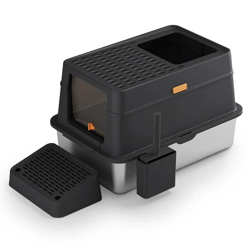 Grey fully enclosed hooded cat litter box with a foot pedal next to the front entrance door.