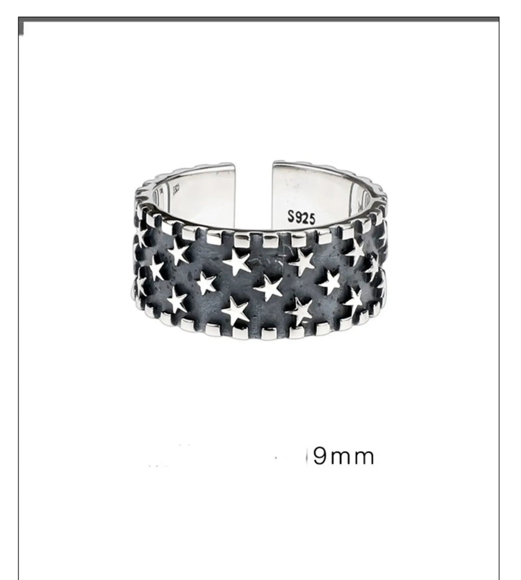 Adjustable sterling silver ring with geometric five-pointed star design on finger