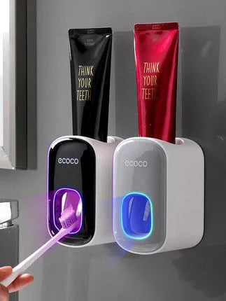 Black wall-mounted automatic toothpaste holder with toothbrush storage and suction cup mounting