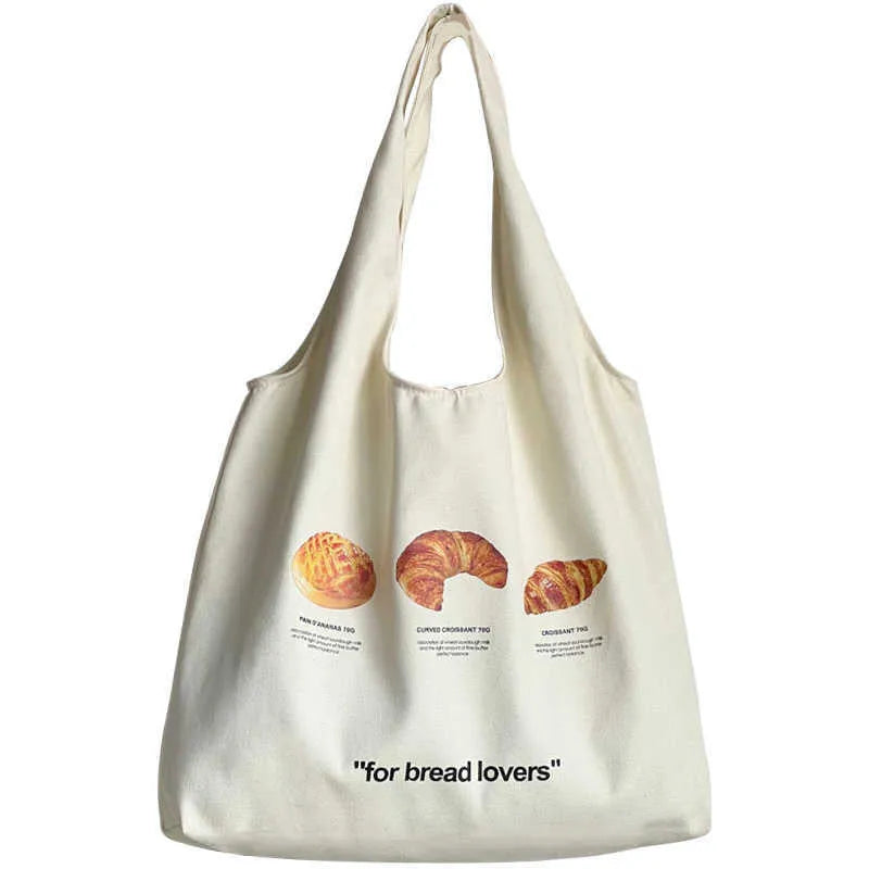 Beige canvas tote bag with croissant-shaped shoulder design and wide 44cm structure