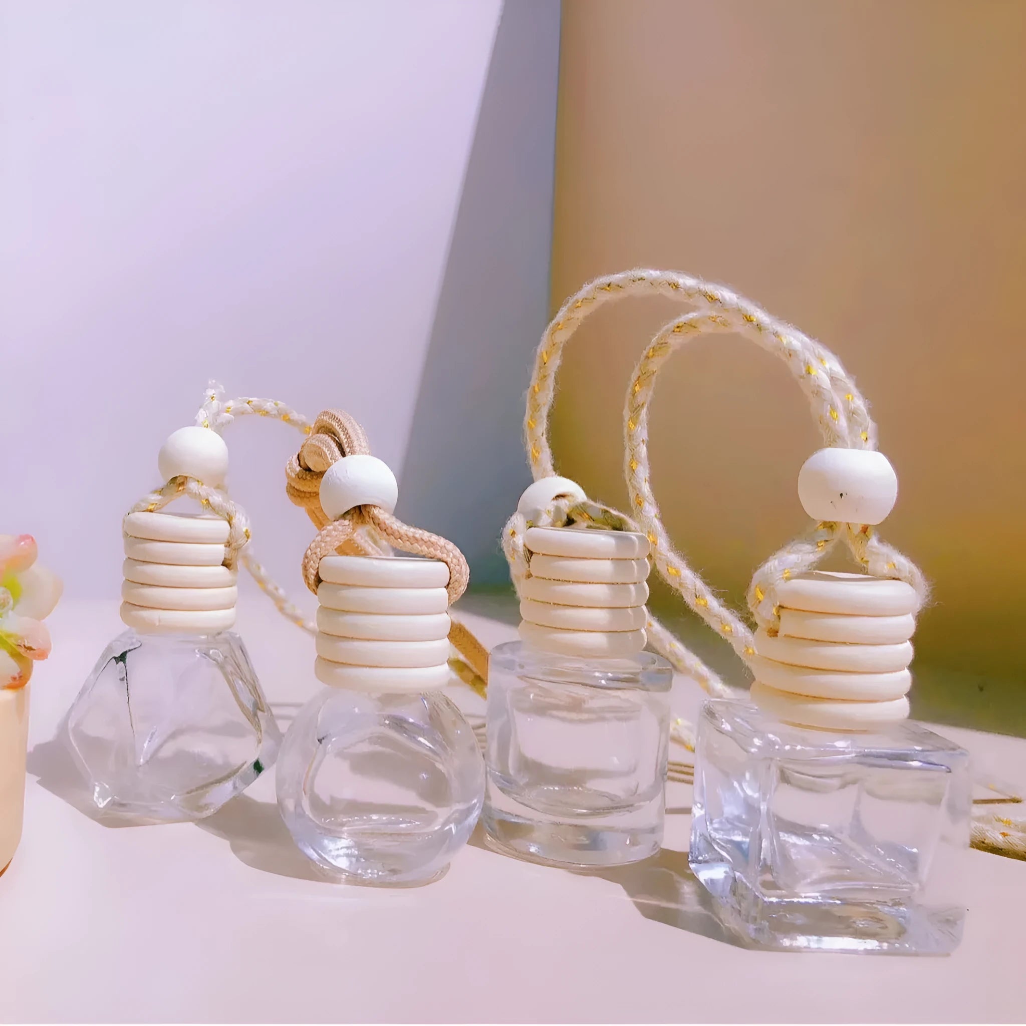 Car perfume pendant in glass bottle showing cylinder, diamond, flat drum and square style options