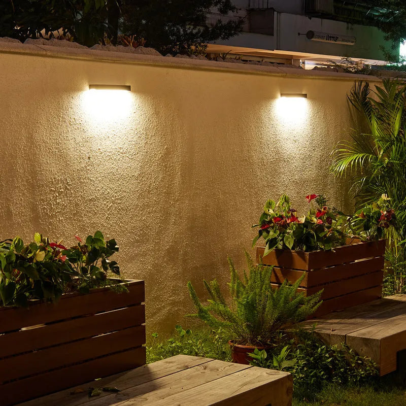 Black solar garden wall light with solar panel and IP65 waterproof rating