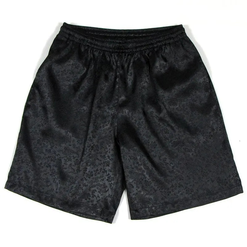 Men's black Tang suit style shorts with an elasticated drawstring waistband laid flat