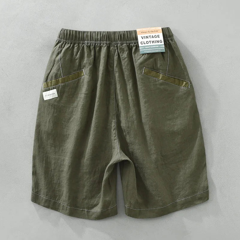 Men's green linen straight shorts with drawstring waist on hanger