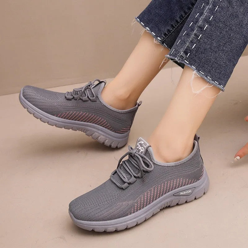 Women's round toe casual sneakers in black with breathable mesh and lace-up front