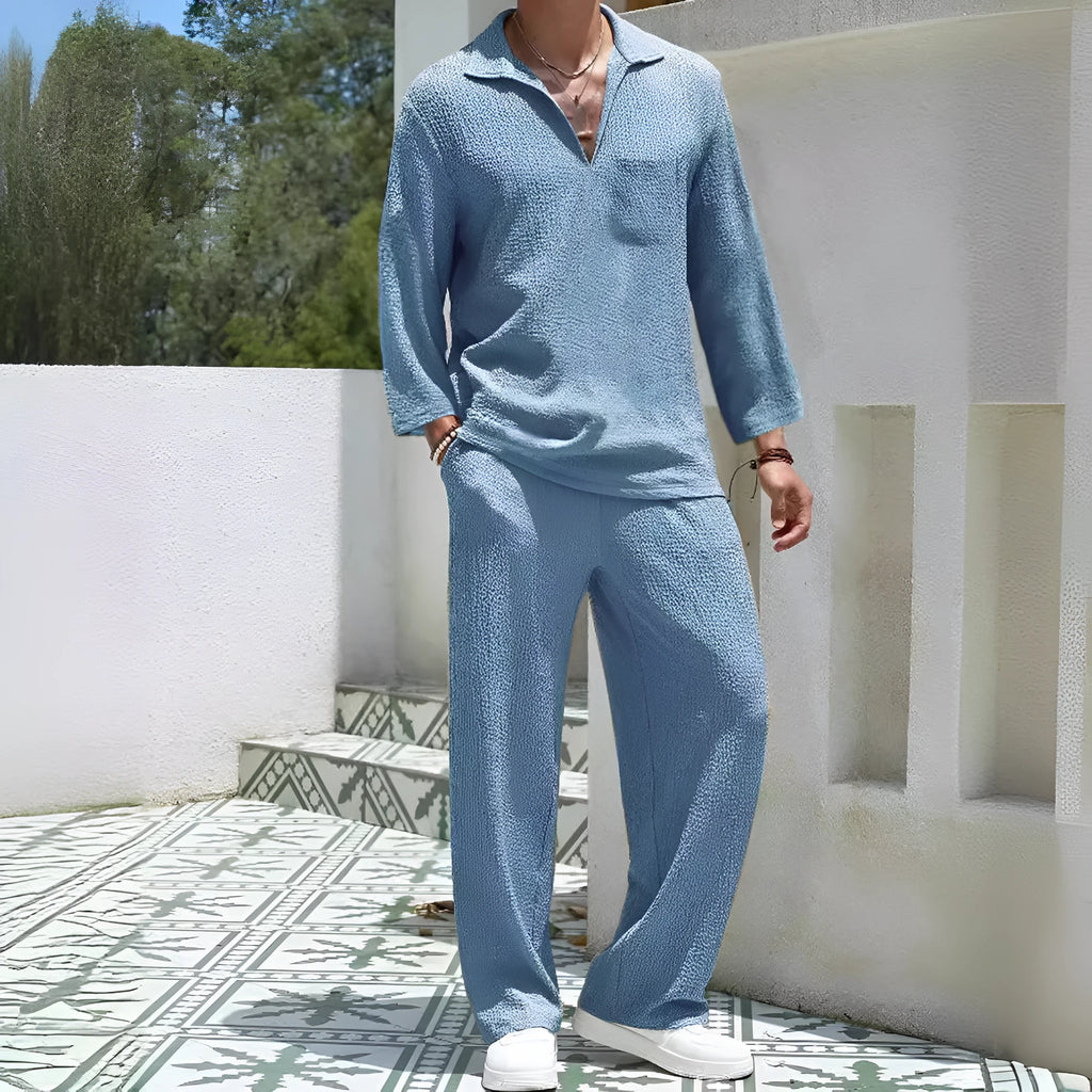 Man wearing a lake blue casual shirt and trouser suit set for autumn leisure.