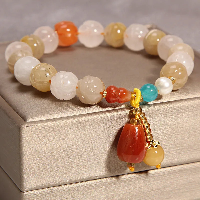 Khaki women's bracelet with yellow agate crystals threaded on a gold silk cord.