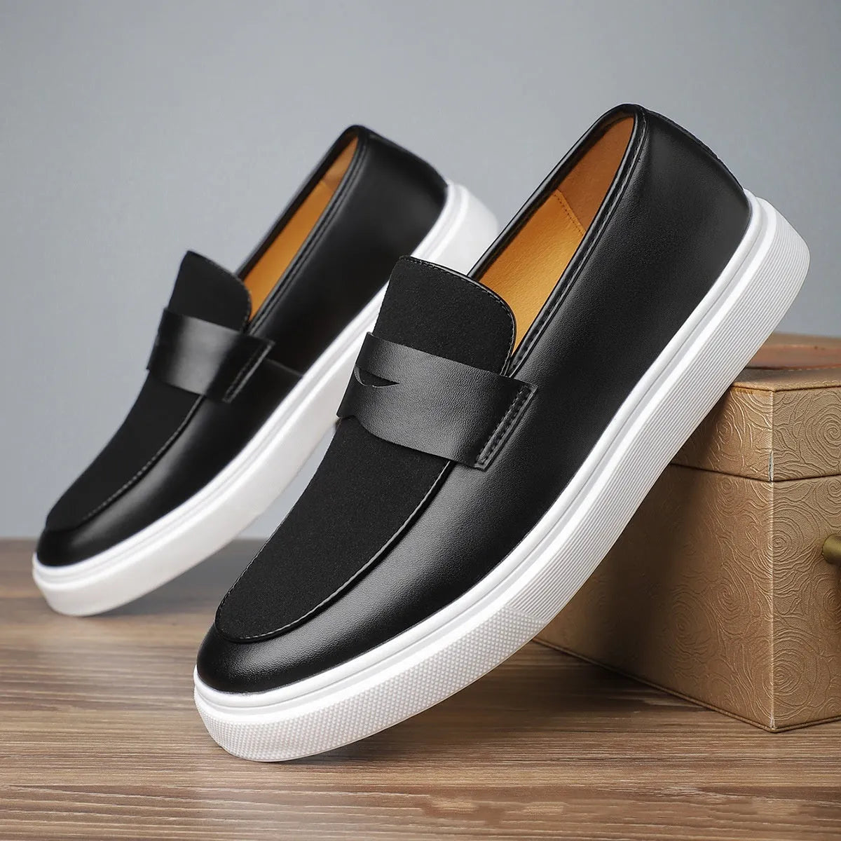 Black men's Gommino slip-on casual shoes with tassel detail and round toe