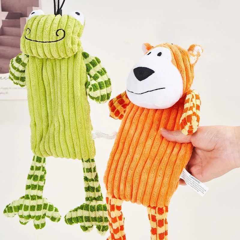 Green and orange plush dog toy with squeaker for aggressive chewing and teeth grinding