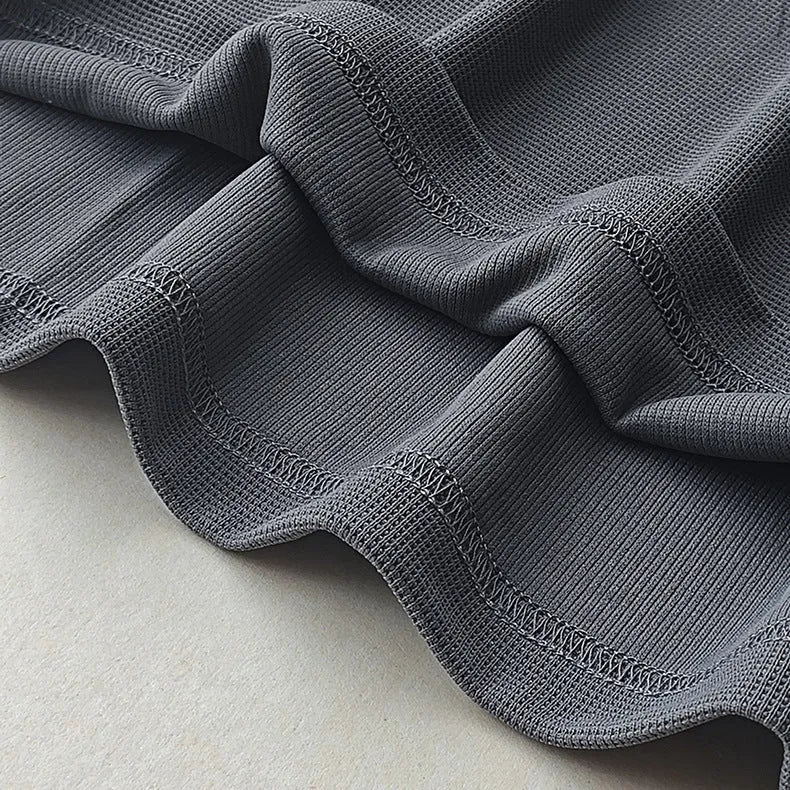 Men's dark grey heavy waffle knit short-sleeved t-shirt on a hanger.