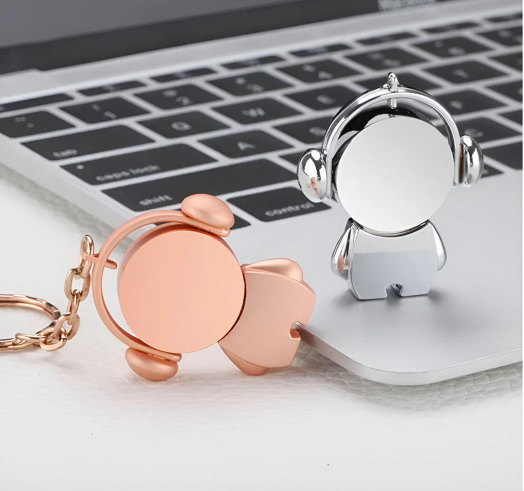 Silver and rose gold metal USB flash drives with a cartoon musician graphic, showing front and side views.