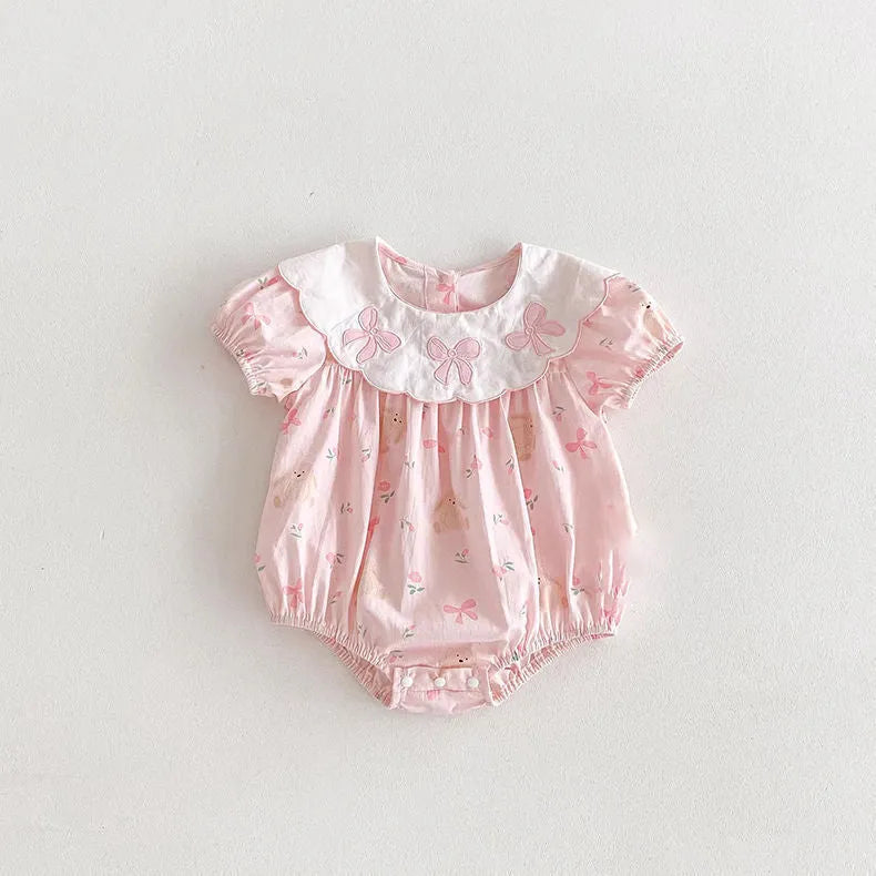 Pink cotton newborn triangle rompers with short sleeves and three bow details for summer outwear