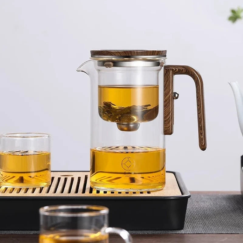 Innovative glass teapot with magnetic separation technology, wooden handle, and clear design for brewing and serving tea