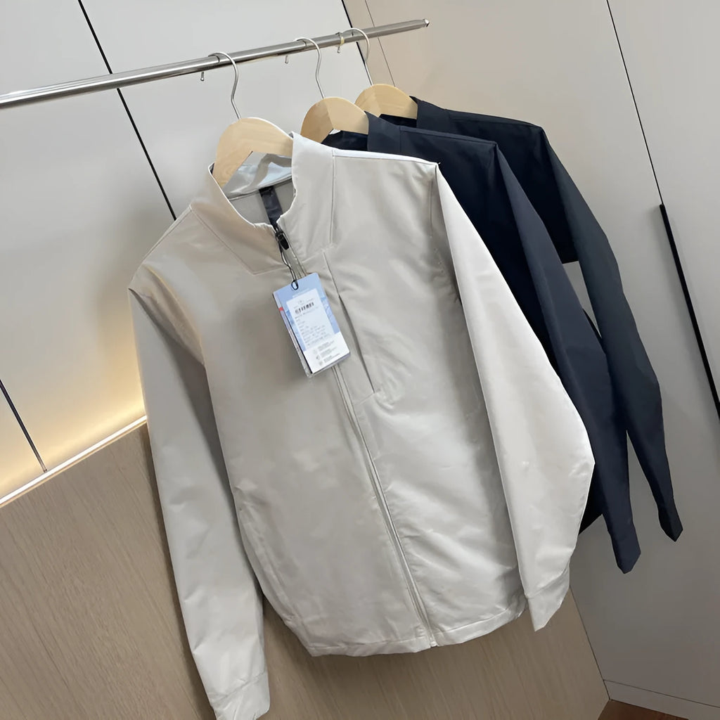 Man wearing a beige stand collar polyester casual jacket with long sleeves and a straight hem.