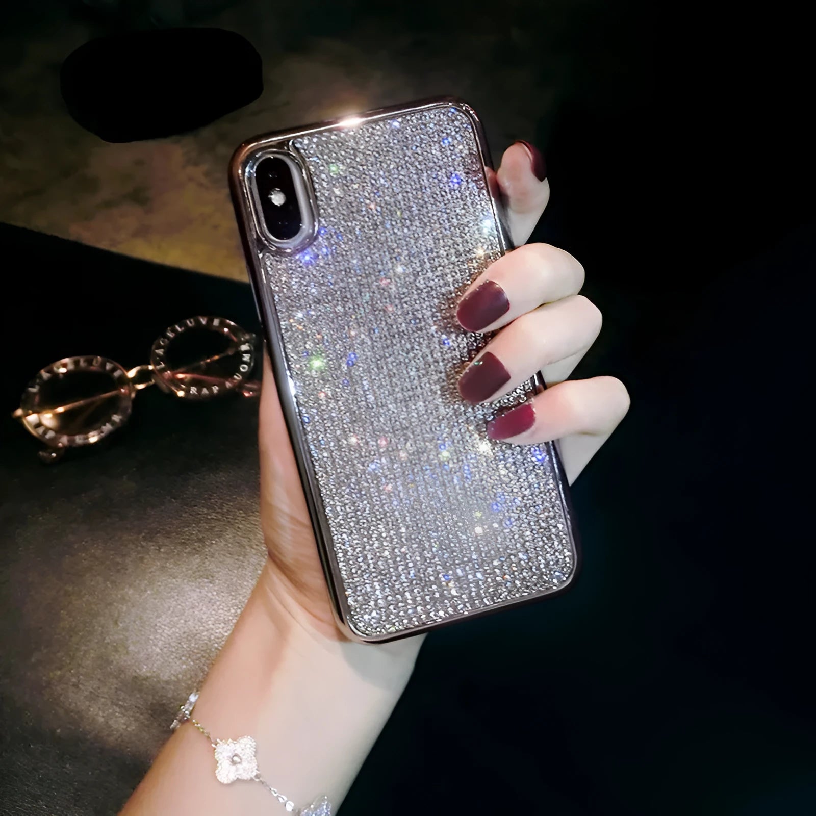 Silver silicone diamond-encrusted phone case for various iPhone models.