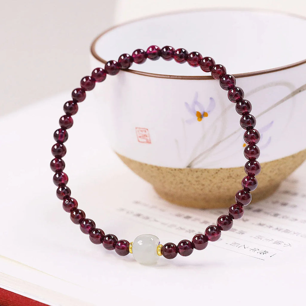 Natural garnet bracelet with U-shaped design showing garnet and dream garnet colour options