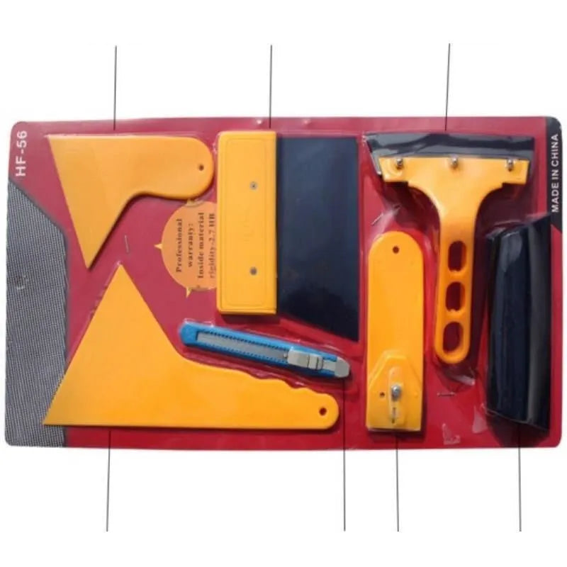 Seven-piece car film tool set including scrapers, knives, and a pressing block on a work surface.
