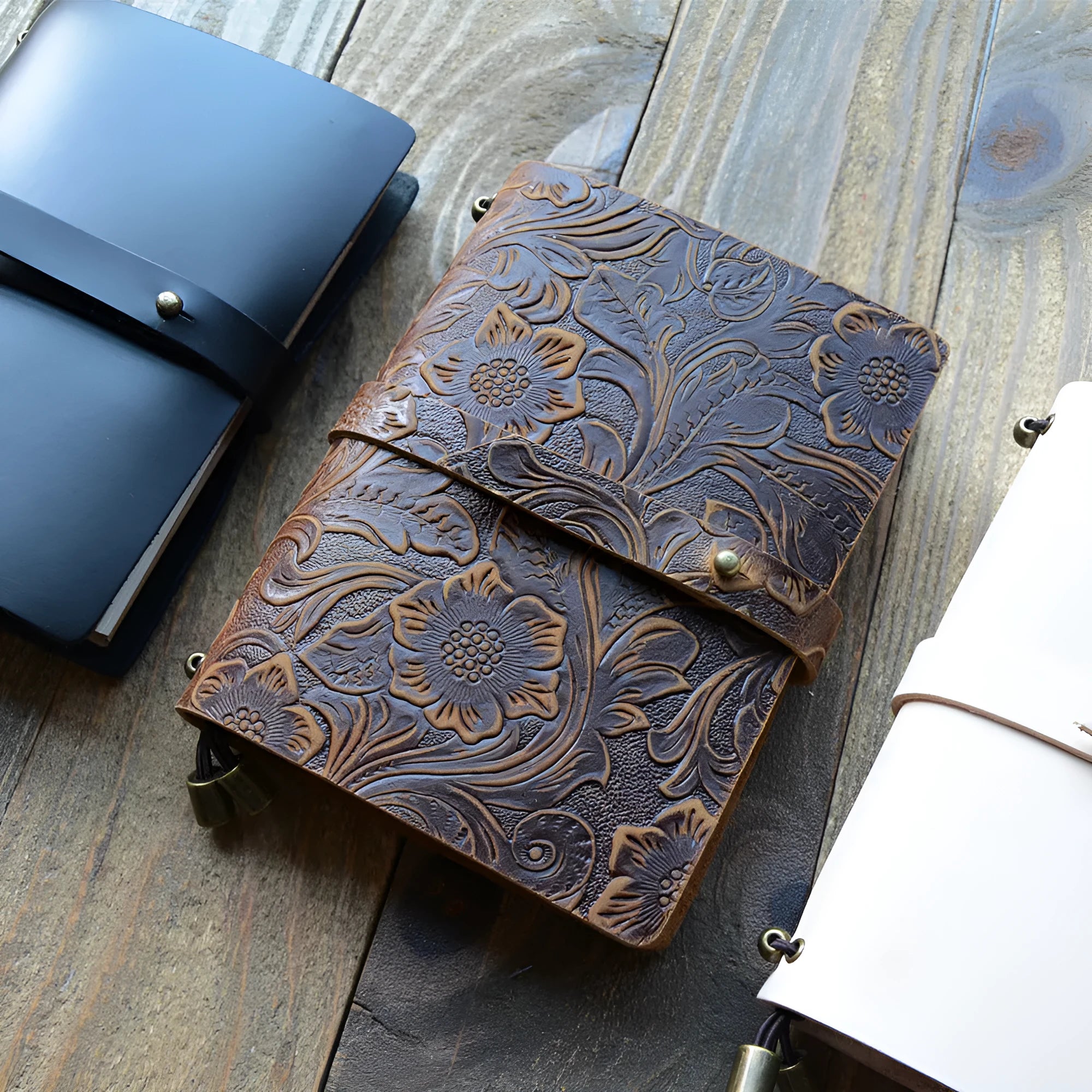 Carved cowhide leather passport holder showing decorative patterns in available colour options