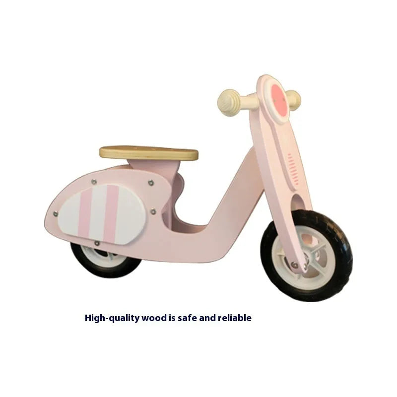 Pink wooden balance scooter for toddlers, 10 inches in size.