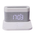 Black and white multifunctional table lamp with integrated digital clock and wireless phone charging pad