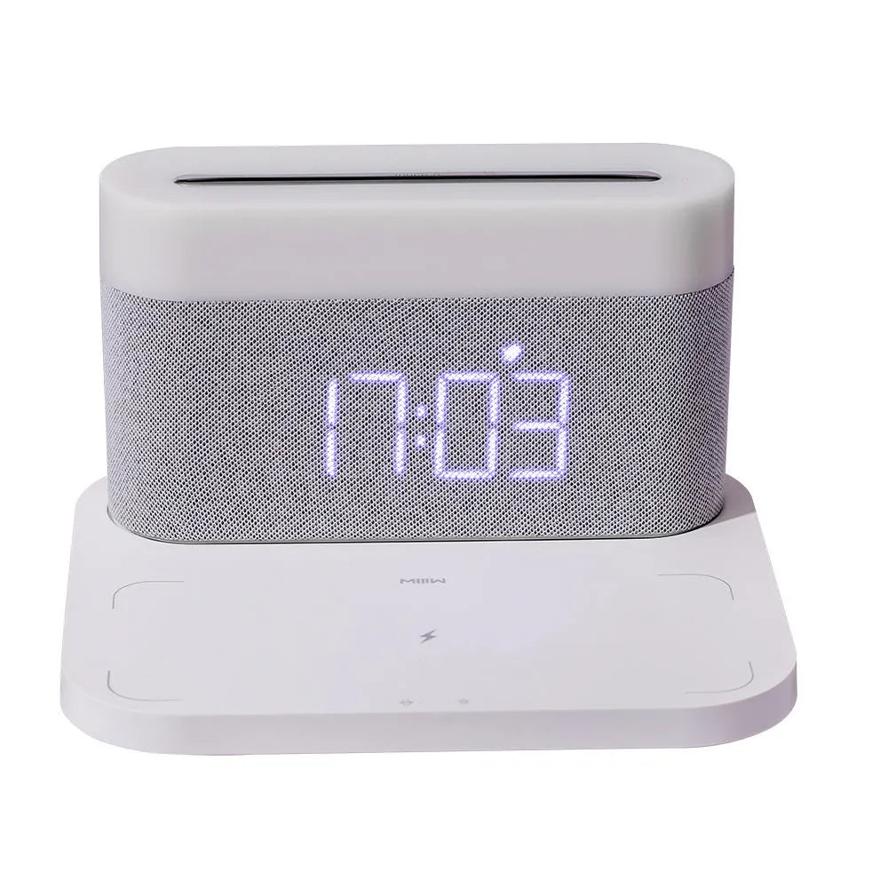 Black and white multifunctional table lamp with integrated digital clock and wireless phone charging pad