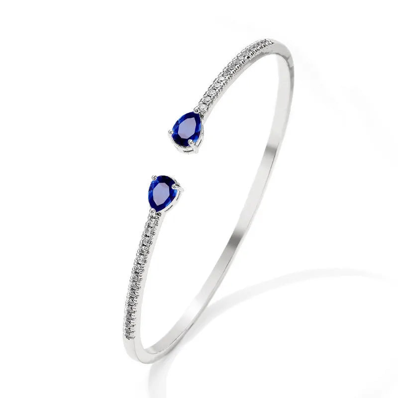 Personalised copper bracelet with multi-zircon inlay, shown in white and blue colour options