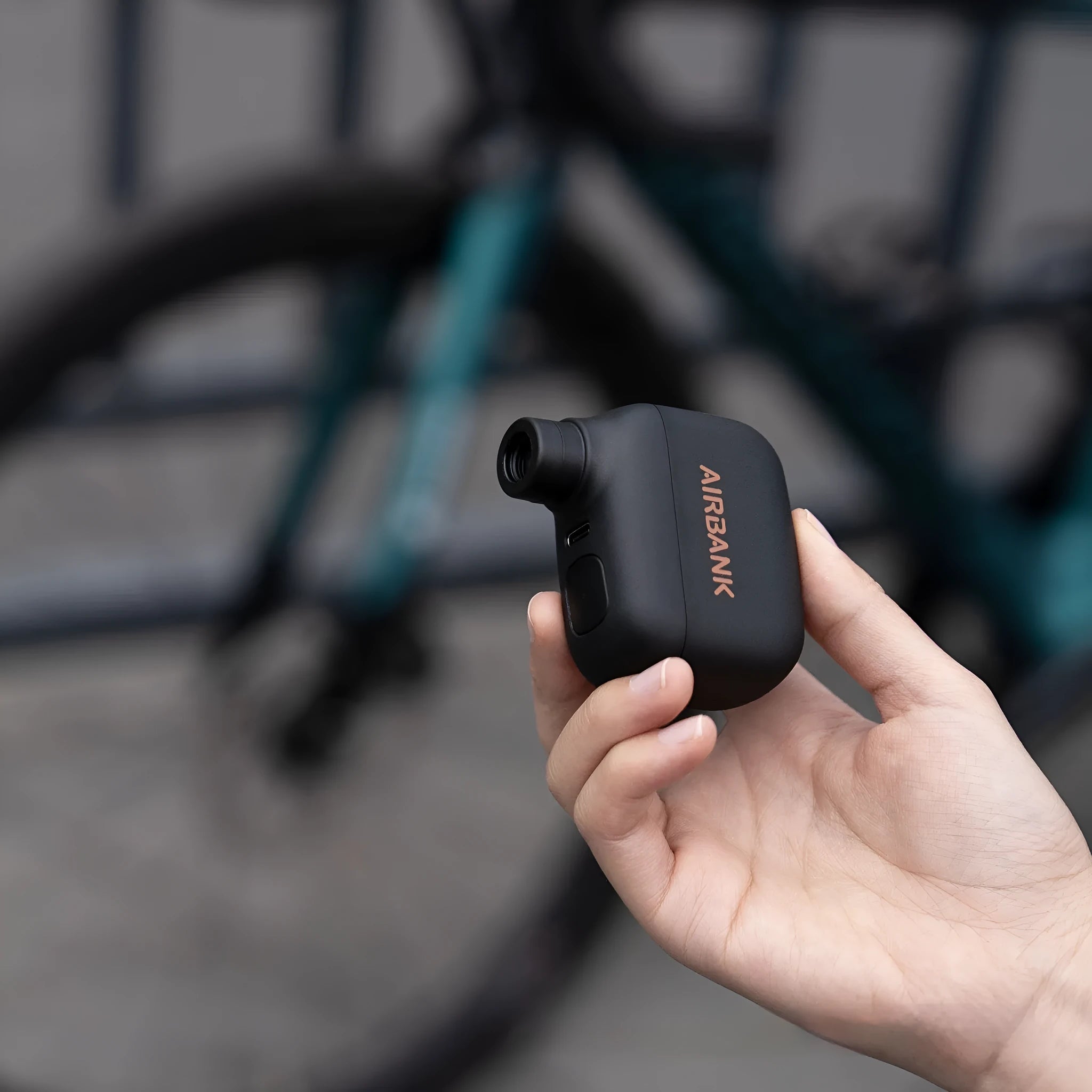 Black electric bicycle tyre inflator pump with USB charging cable and waterproof storage bag