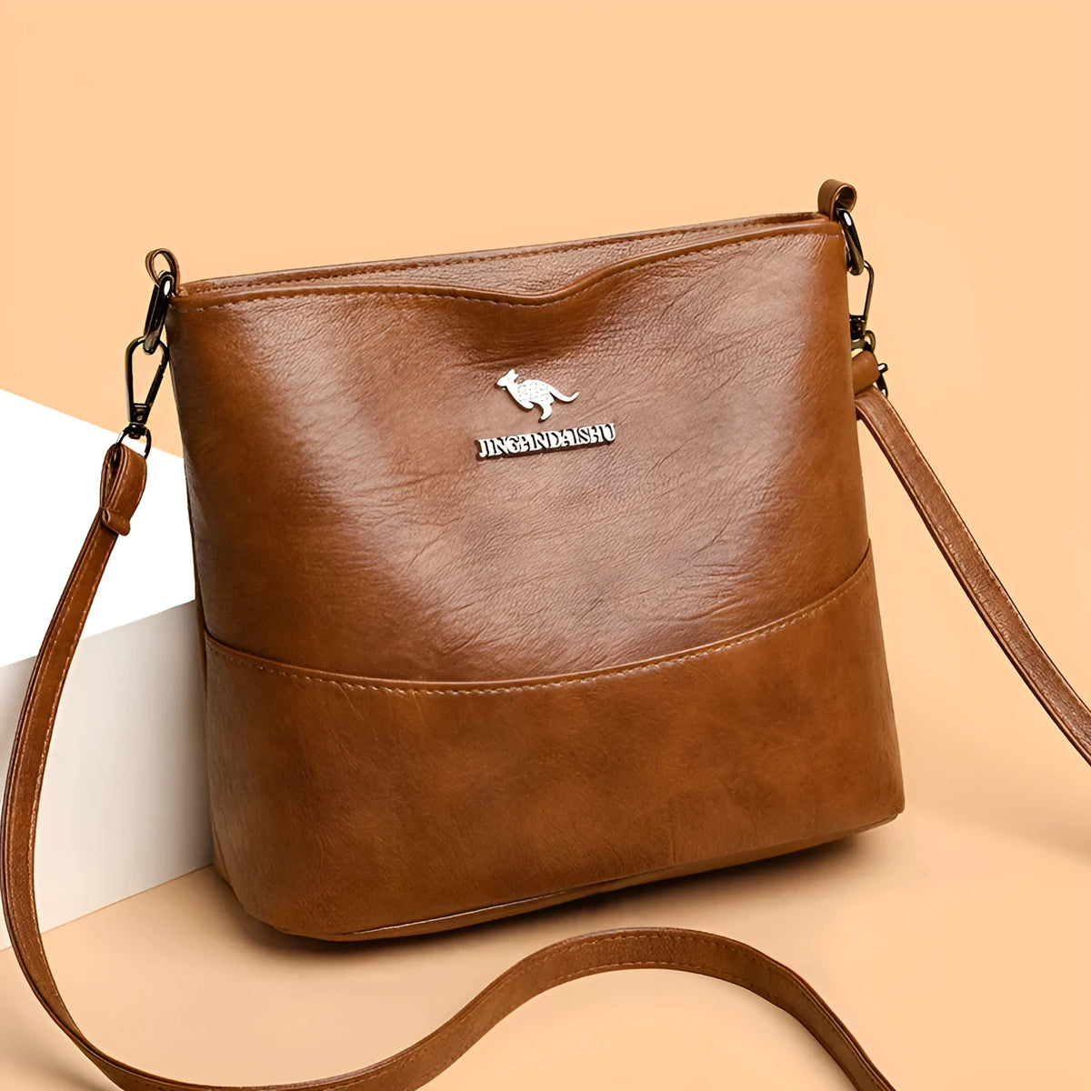 Women's PU leather crossbody bucket bag with wide strap, outer slit pocket, and internal phone and file pockets.