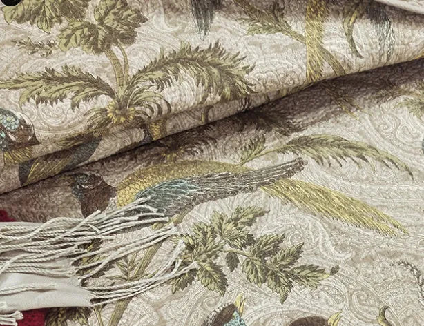 Blue American floral and bird patterned cotton quilted bedspread set on a bed, showing the 230x250 cm size