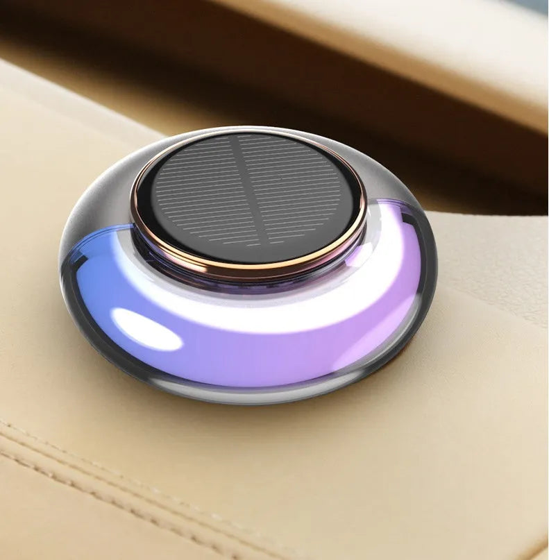 Car solar charging fragrance with built-in motor, round shape, grey colour, on car dashboard