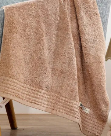 Cotton towel set in beige and brown showing face, hand, and bath towel sizes