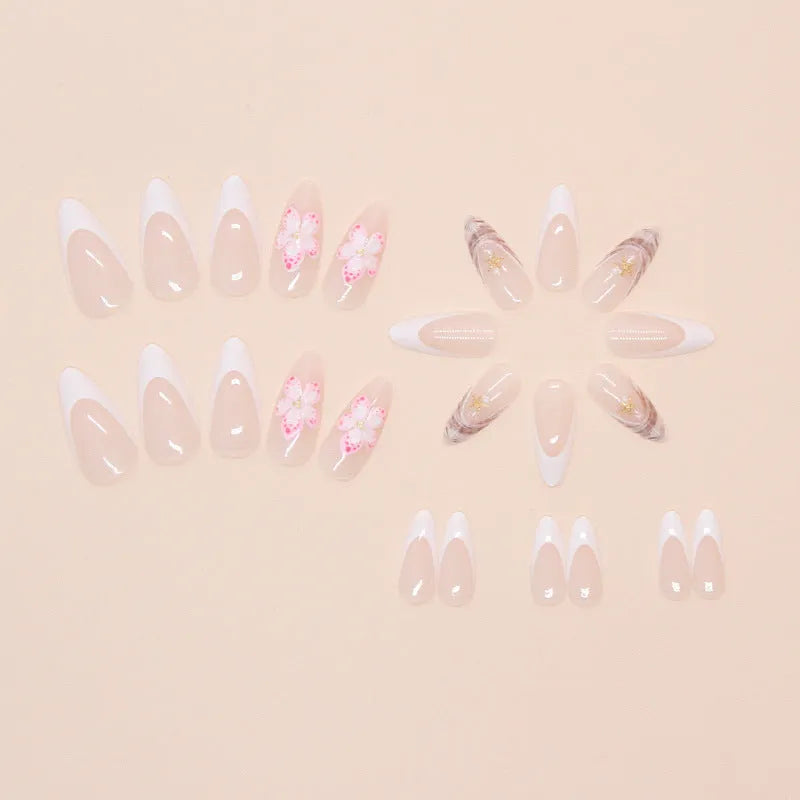 One pair of French style plastic false nails with a simple floral rock design and a bottle of nail glue.