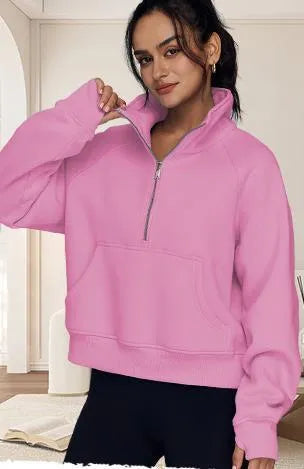 Woman wearing a loose lapel fleece-lined sweater in a solid colour, showing raglan sleeve detail.