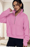 Woman wearing a loose lapel fleece-lined sweater in a solid colour, showing raglan sleeve detail.