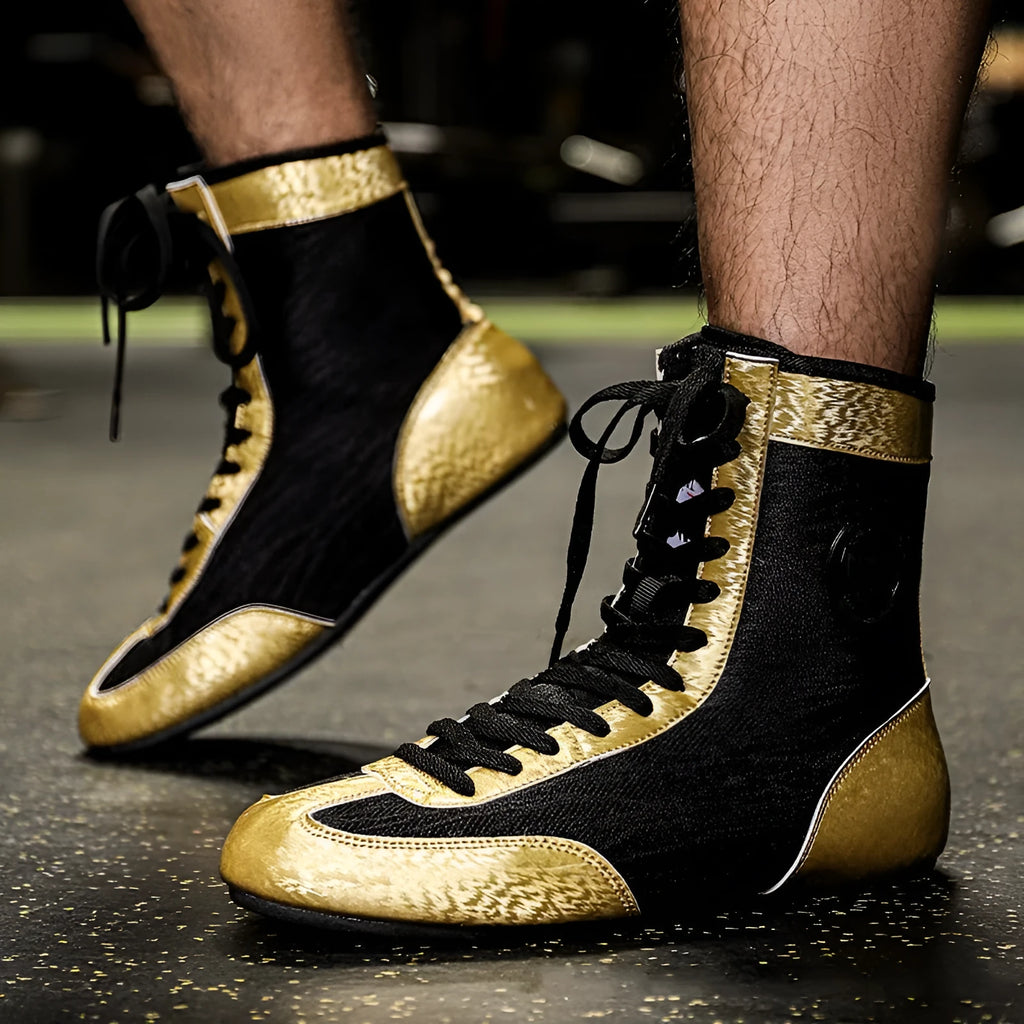 Professional black gold mesh boxing shoes with white leather panels and black detailing, shown in size 42.