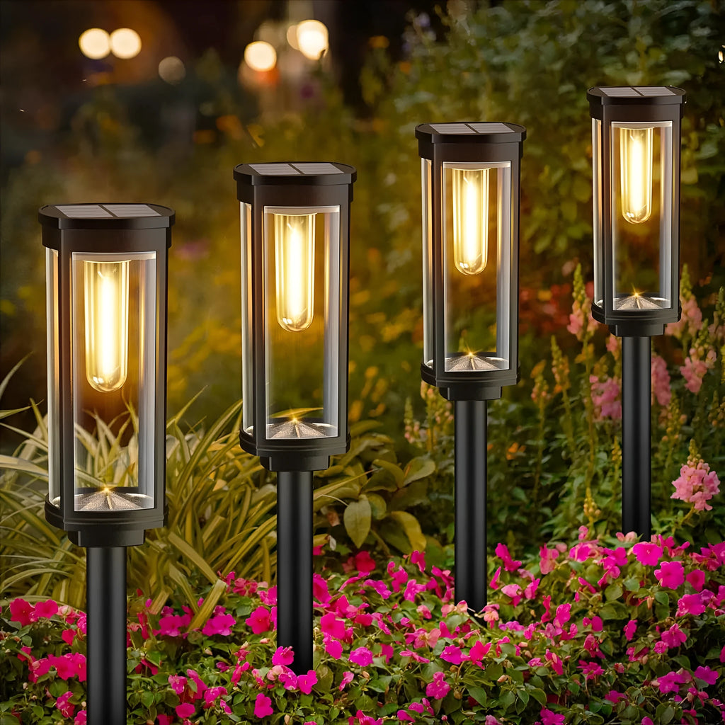 Round tungsten wire solar lawn lamp on grass in a garden courtyard emitting warm light