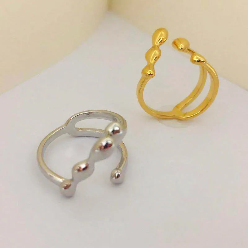 Brass opening ring for women with spherical design in gold or silver finish.