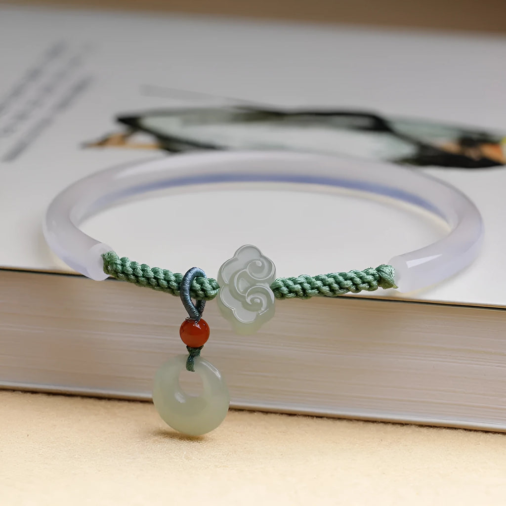Handmade natural white agate bracelet with jade green Hetian jade charm on an adjustable cord.