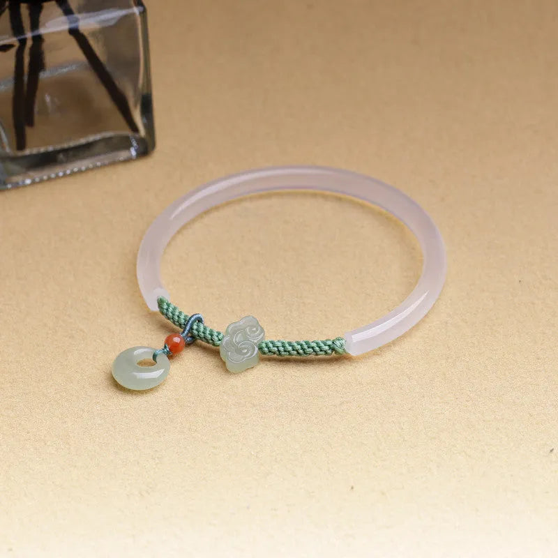 Handmade natural white agate bracelet with jade green Hetian jade charm on an adjustable cord.