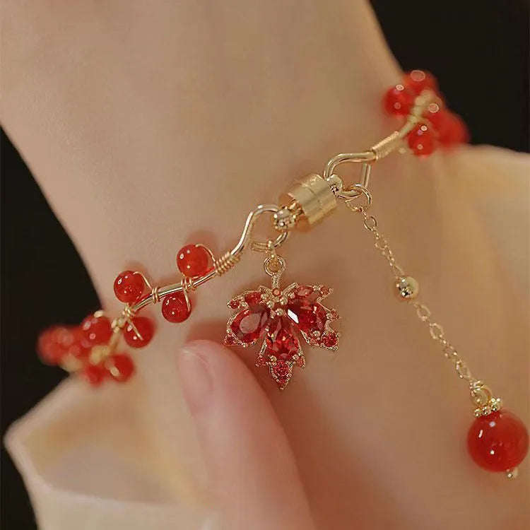 Red Chinese style magnetic bracelet with maple leaf and ginkgo leaf designs on alloy band