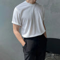 Men's slim fit plain cotton t-shirt in white on a hanger, showing round neck and half sleeve design.