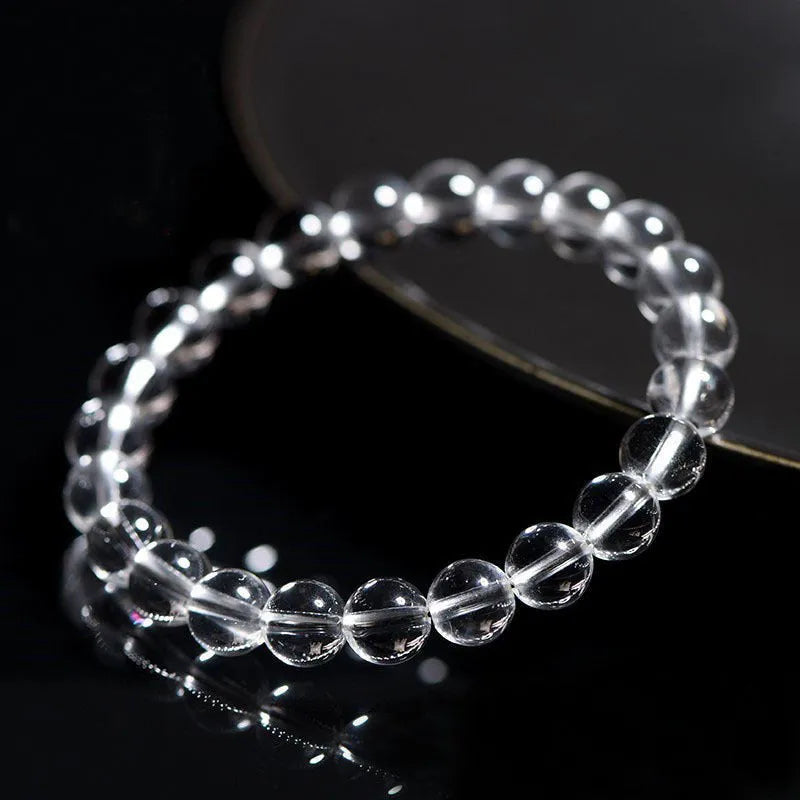Natural old mine white crystal bead bracelet with geometric design on a wrist.