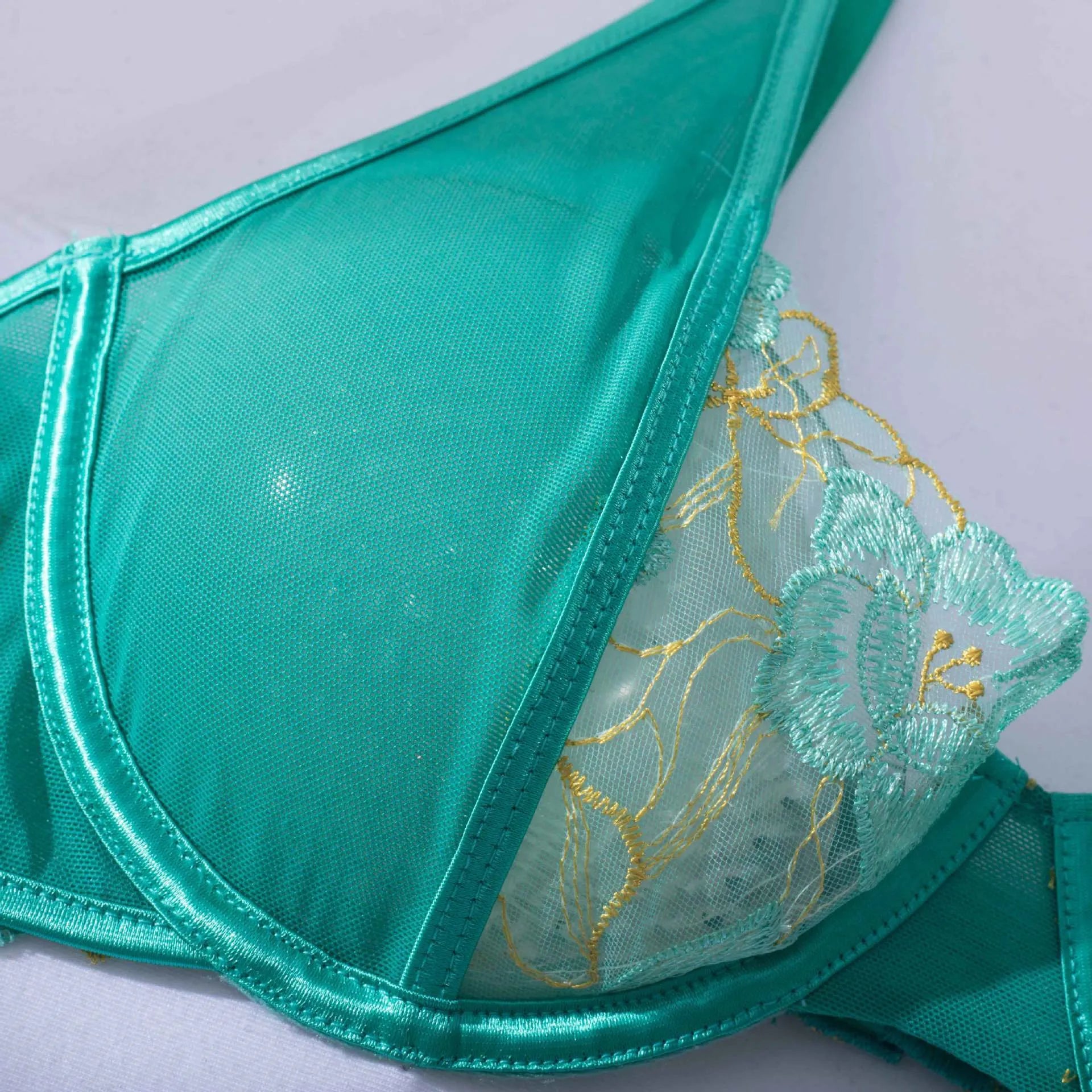 Light green embroidered women's bra and bikini set in three-point style.