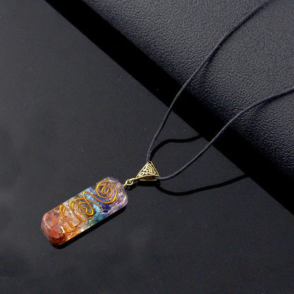 Chakra-inspired acrylic pendant with a unique geometric design and natural variations in the stone patterns