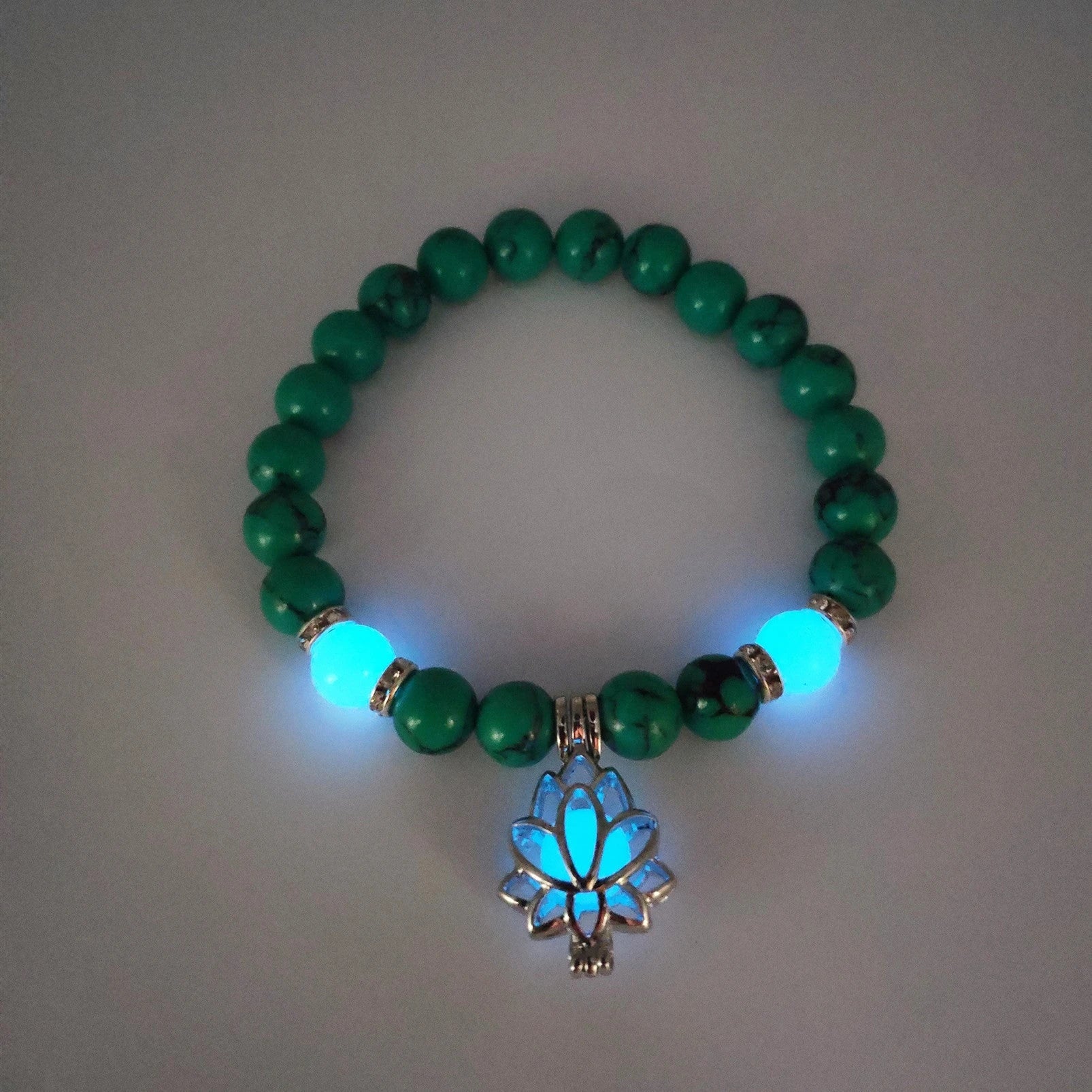 Luminous lotus charm bracelet with mesmerizing glow-in-the-dark beads, made of premium alloy and turquoise fluorescent stone