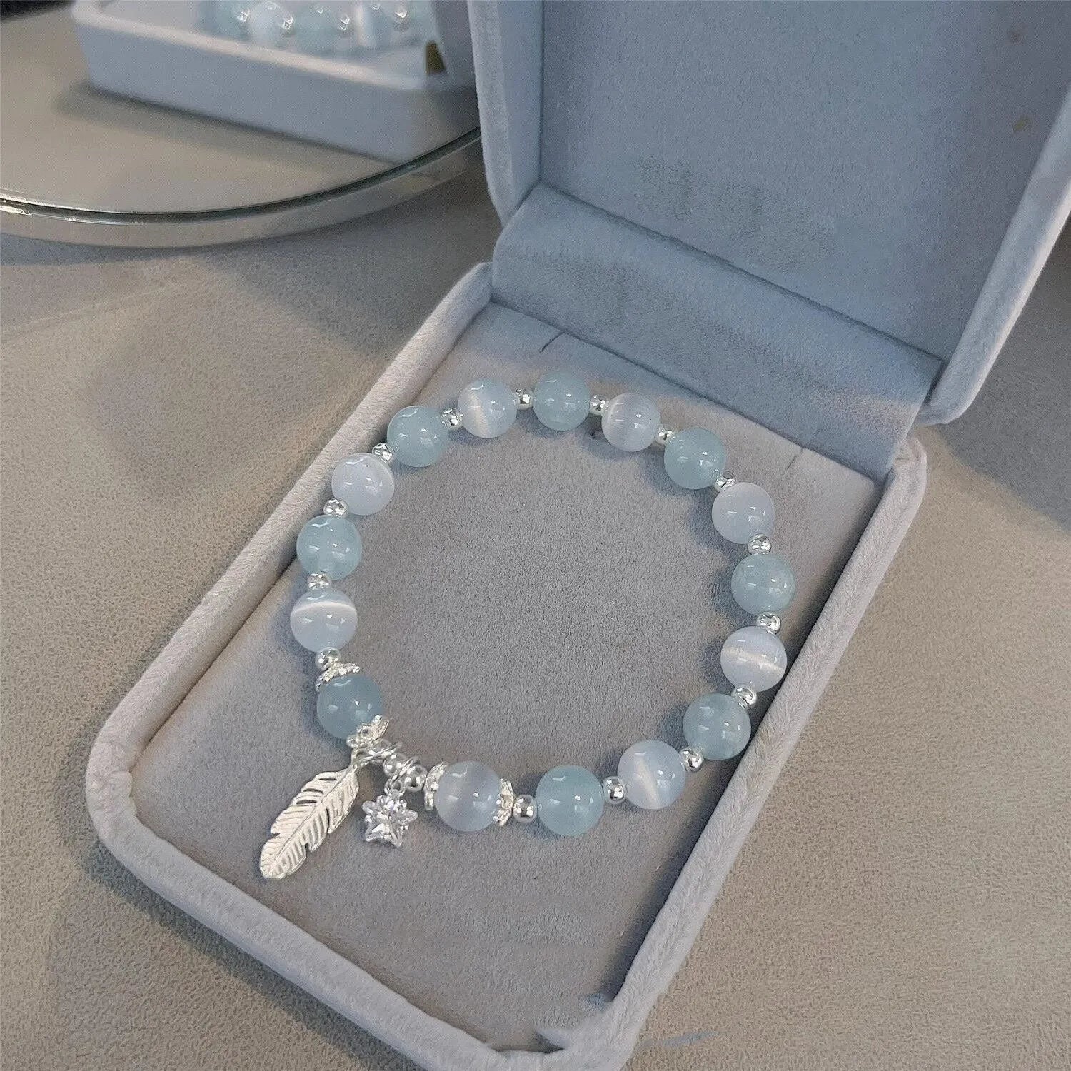 Small white girl crystal bracelet with feather XINGX blue moonlight colour and eight awn star details