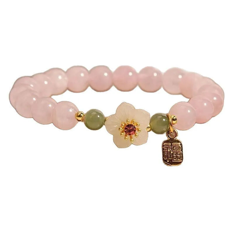 Crystal and Hetian Jade beaded bracelet with peach blossom design and adjustable cord.