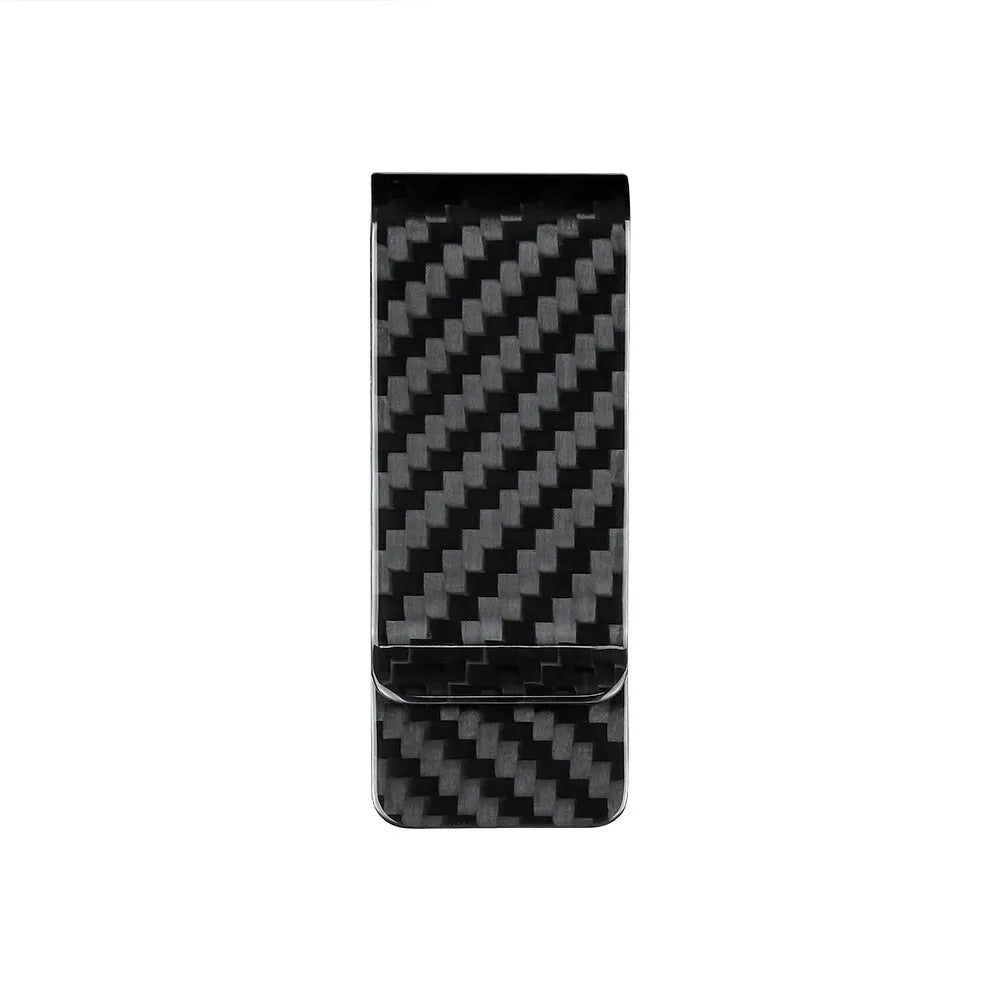 Black glossy striped carbon fibre money clip on a flat surface showing its slim profile and textured pattern