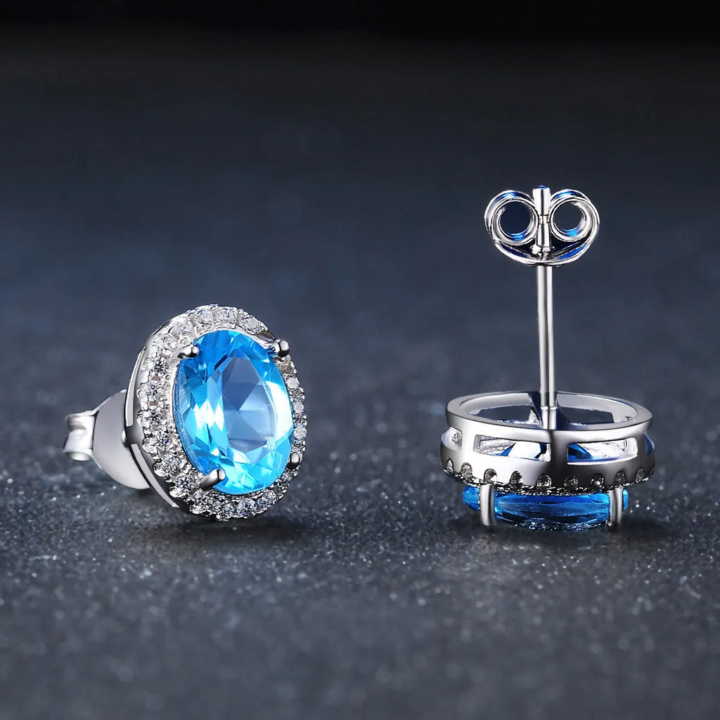 Geometric sterling silver jewellery set with blue topaz gems including earrings, ring, pendant and necklace